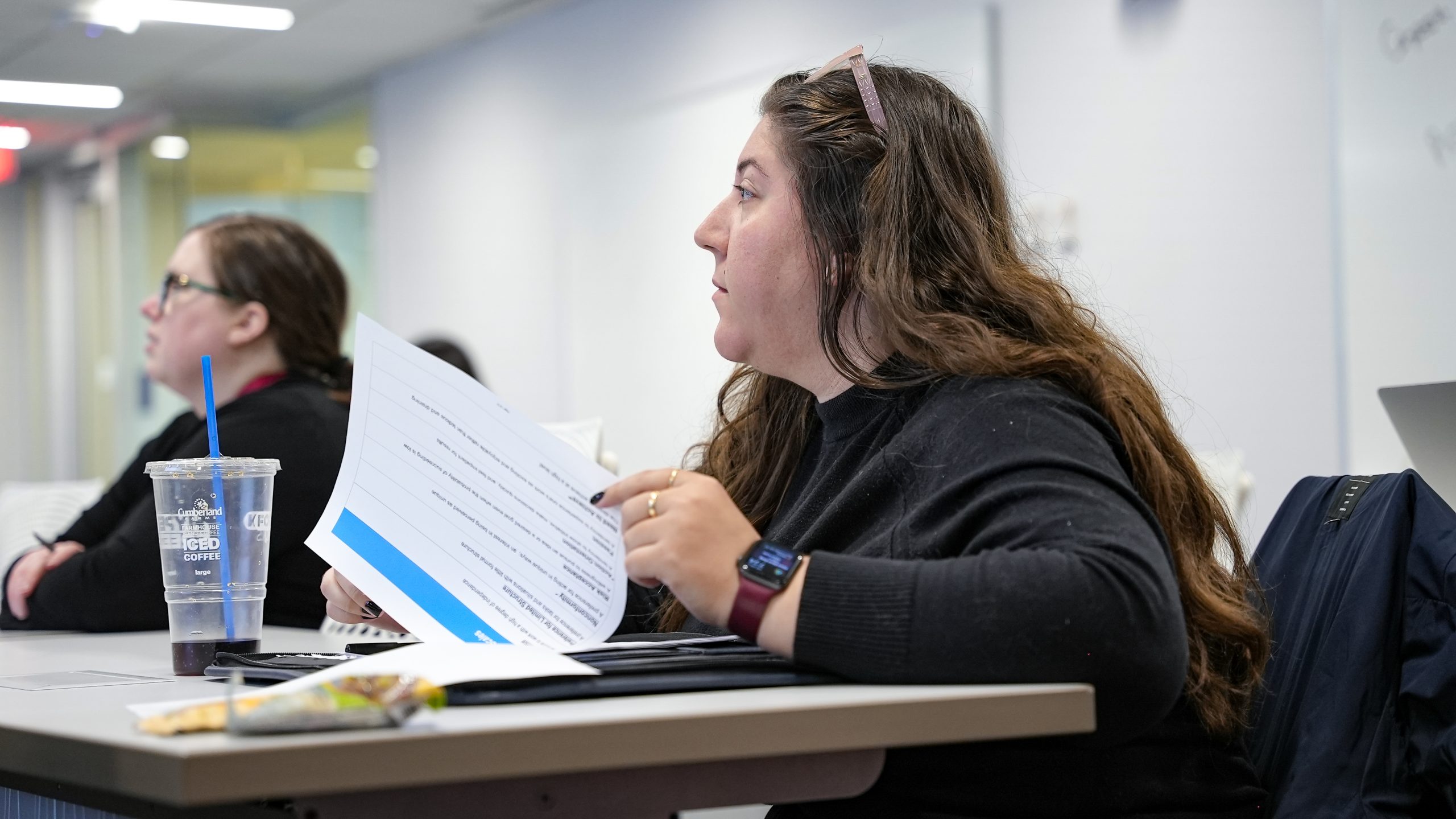 Two women during an ELP session listening to the presentation